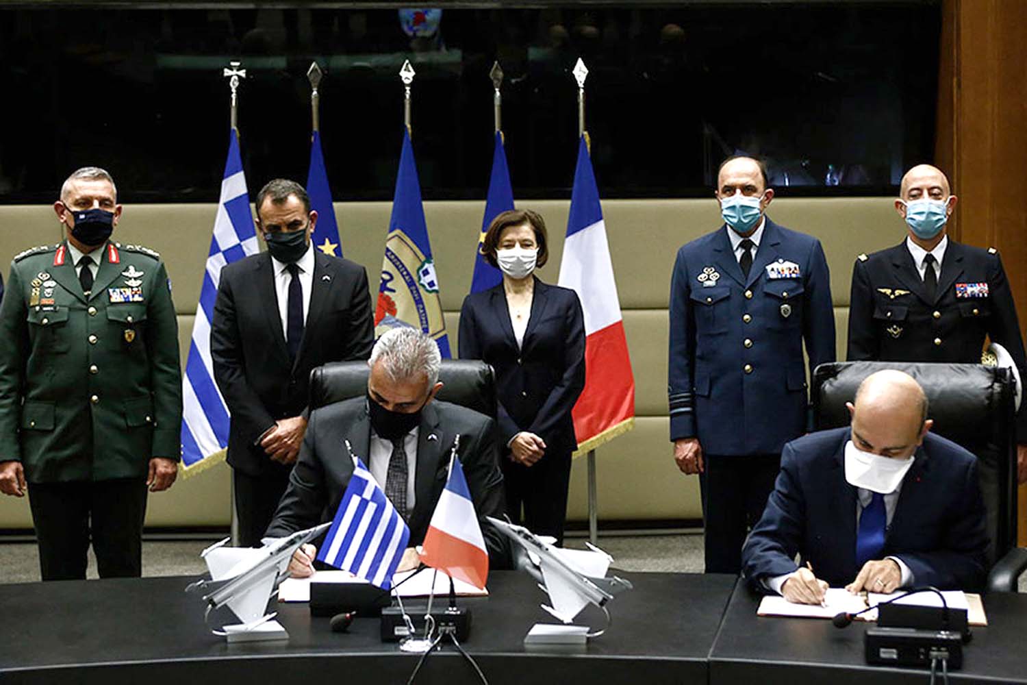 Theodoros Lagios, director general de Armamento e Inversiones del ministerio de Defensa griego y Eric Trappier, presidente de Dassault firman la comrpa de los Rafale.